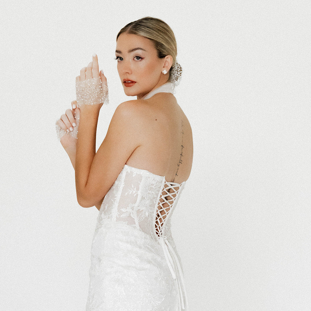 Side view of The Elise Mini highlighting the subtle front slit and fitted silhouette.